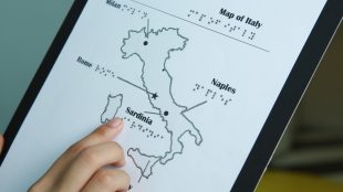 map of italy printed with touchable ink. Shows raised image of italy with some cities printed in text and braille.