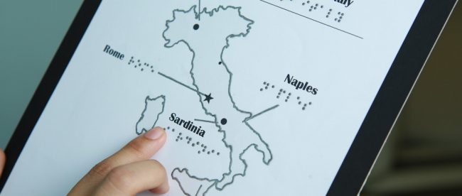 map of italy printed with touchable ink. Shows raised image of italy with some cities printed in text and braille.