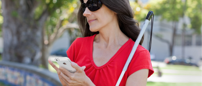 a blind woman navigating an iPhone with her right hand