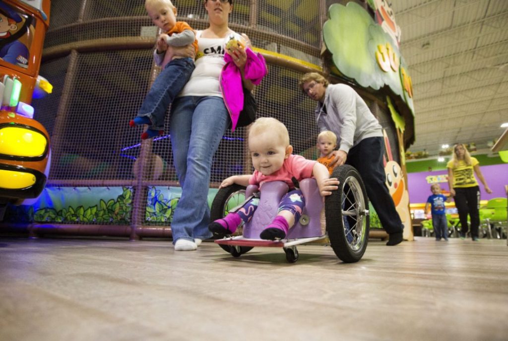 Evelyn seen wheeling around in a public place in her DIY wheelchair that her parents built her.