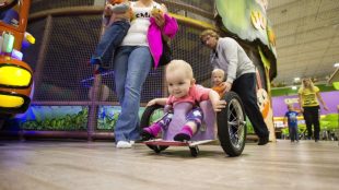 Evelyn seen wheeling around in a public place in her DIY wheelchair that her parents built her.