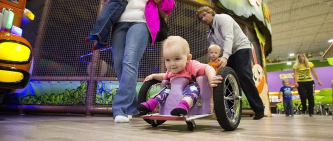 Evelyn seen wheeling around in a public place in her DIY wheelchair that her parents built her.