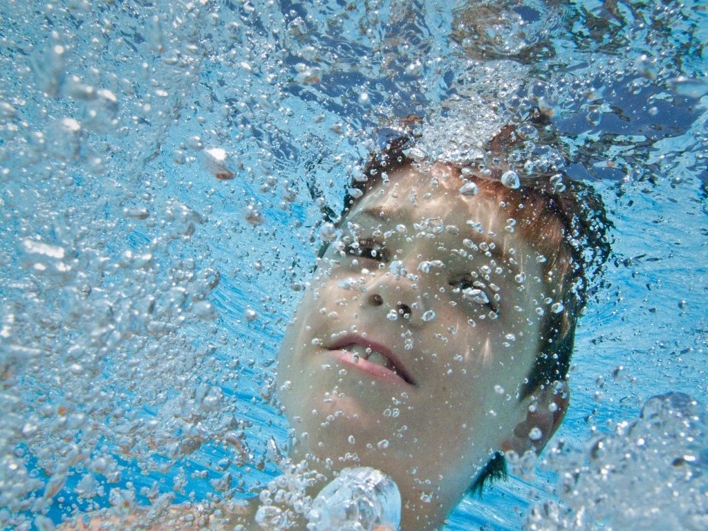 A close up of Bruce's son underwater.