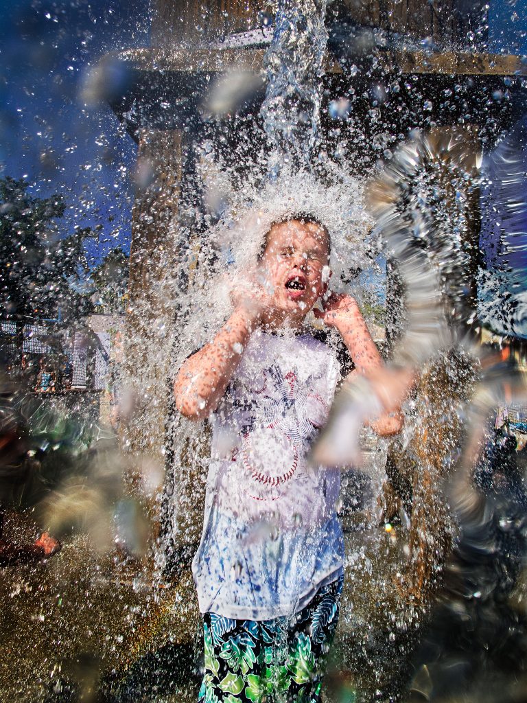 a large amount of water being poured on Bruce's son