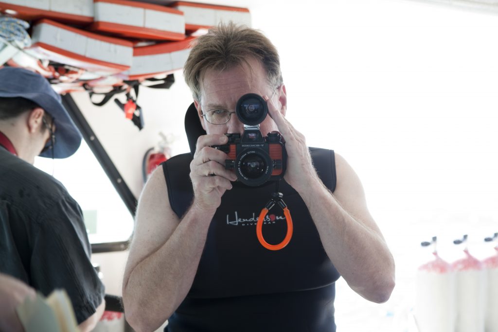 Bruce seeing through the viewfinder of his camera.