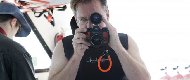 Bruce seeing through the viewfinder of his camera.