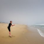 Bruce's son jumping at a beach.