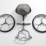 parts of Go wheelchair - photo shows 2 wheels, seat and footrest.