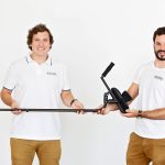 two men holding a KMINA crutch.
