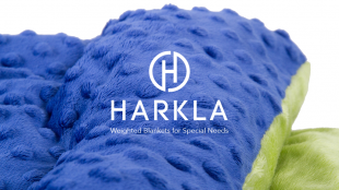 image of a weighted blanket colored blue and yellow with harkla logo displayed in the center.