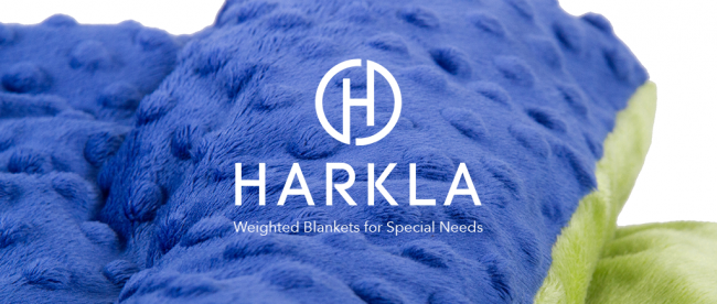 image of a weighted blanket colored blue and yellow with harkla logo displayed in the center.