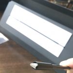 The touchfunction is made of soft silver fibers that gently hits the touch screen yet registers a touch. Here it is seen resting inside the tube. When a user puffs from the other end of the tube, this touchfunction extends out and gently hits the touchscreen.