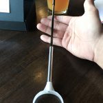 Very light, comfortable, and sturdy. Very thin, and around 12 inches long. Seen here resting on a person's hand.