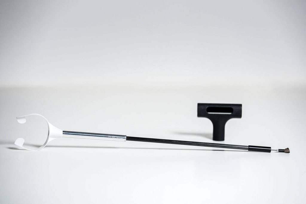 TubusOne shown with an attached mouthpiece. There is also a stand resting in the background.