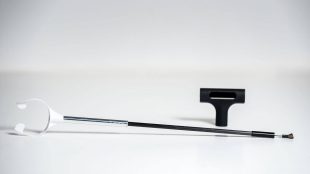 TubusOne shown with an attached mouthpiece. There is also a stand resting in the background.