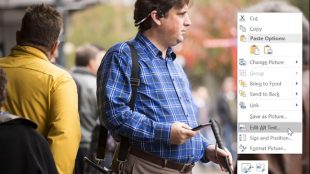 A photo displayed on a computer of a man wearing bone conducting headsets, and holding a phone in his right hand and a cane in his left. To the right is the context menu (right click menu) from an office product, and the option "edit alt text" is highlighted"