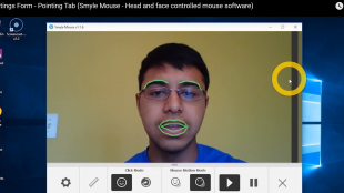 A user is seen using smyle mouse on a computer. The smyle mouse software highlights his eyebrows and lips in a separate window showing that it detects his facial expressions.