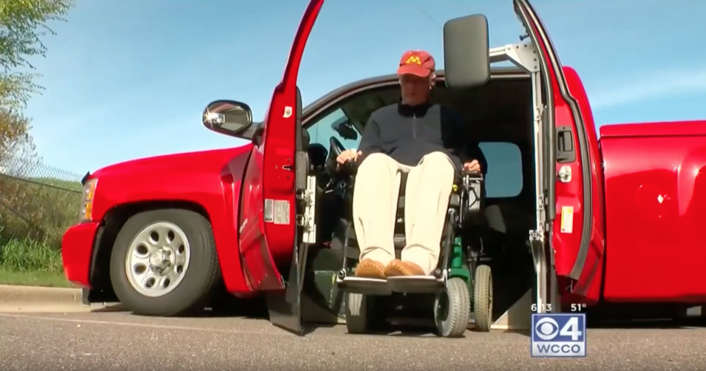 Phil seen getting out of his truck in his wheelchair. His modified Silverado uses his "KAS" system that can lift and lower a vehicle completely to the ground and eliminates the need for a ramp to get in and out of the vehicle.