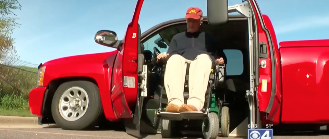 Phil seen getting out of his truck in his wheelchair. His modified Silverado uses his 