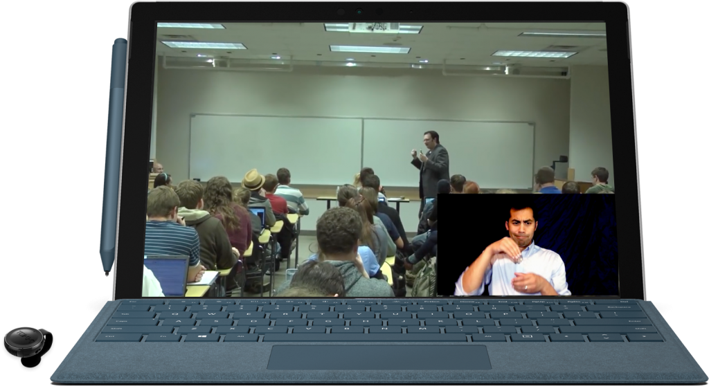 a computer screen showing a class in session. A professor is seen teaching a class full of students. On the bottom right corner of this video is an overlay with an interpreter seen signing the professor in real time.