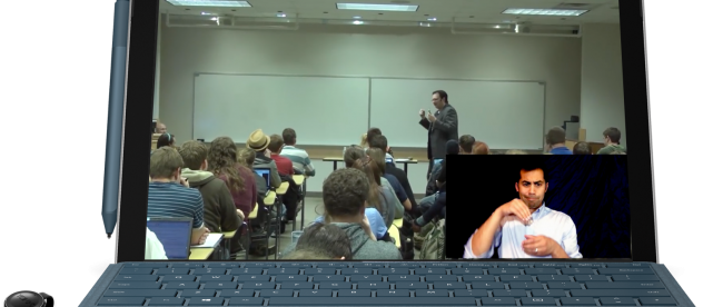 a computer screen showing a class in session. A professor is seen teaching a class full of students. On the bottom right corner of this video is an overlay with an interpreter seen signing the professor in real time.