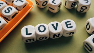 the word love assembled in boggle pieces.