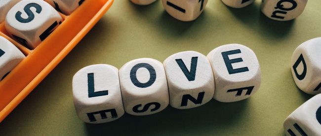 the word love assembled in boggle pieces.