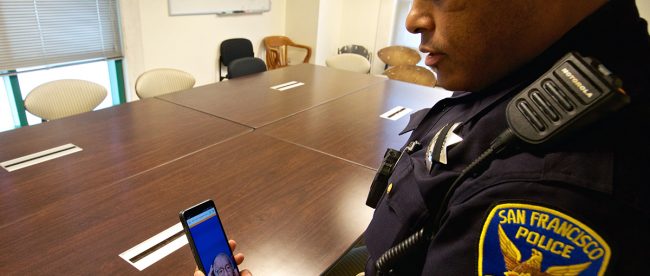 a San Francisco Police Department officer is seen holding his phone and interacting with a sign language interpreter through the app in order to provide better communication to deaf community members.