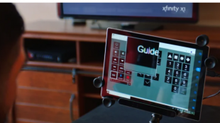 the comcast remote interface shown on a tablet. Jimmy is seen dwelling on the "Guide" button.