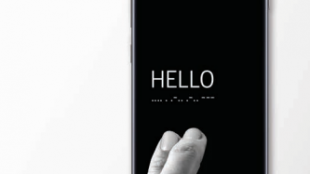 image of a samsung phone with the good vibes app interface. It displays the word hello in english and morse code. Someone's fingers are resting on the phone as if they just tapped the word.