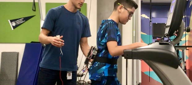 connor seen working with a child wearing the fanny pack exoskeleton