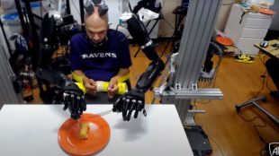 Buz seen controlling both prosthetic arms using BCI