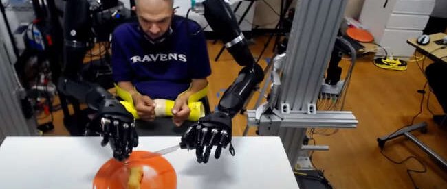 Buz seen controlling both prosthetic arms using BCI