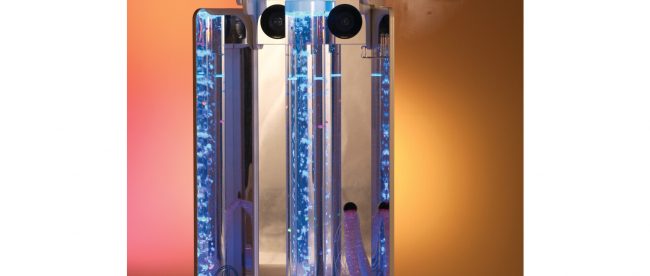 Vecta Deluxe Mobile Sensory Station shown with blue bubbles in the bubble tube and is projecting some calming graphics on a orangish wall.