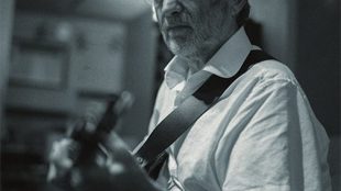 black and white photo of Trevor Owen playing the guitar