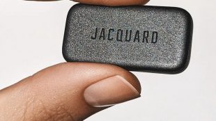 Close up of someone holding jacquard between their thumb and finger