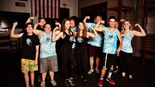 Sarah Parison and Lillie Visa, founders of ABLE FIT seen with gym members flexing their muscles!