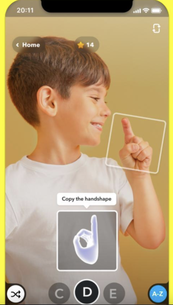 a young boy copying handshapes from the asl alphabet lens on snapchat