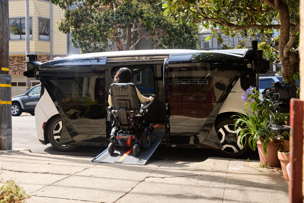 a woman in a powered wheelchair seen entering the wheelchair accessible robotaxi.