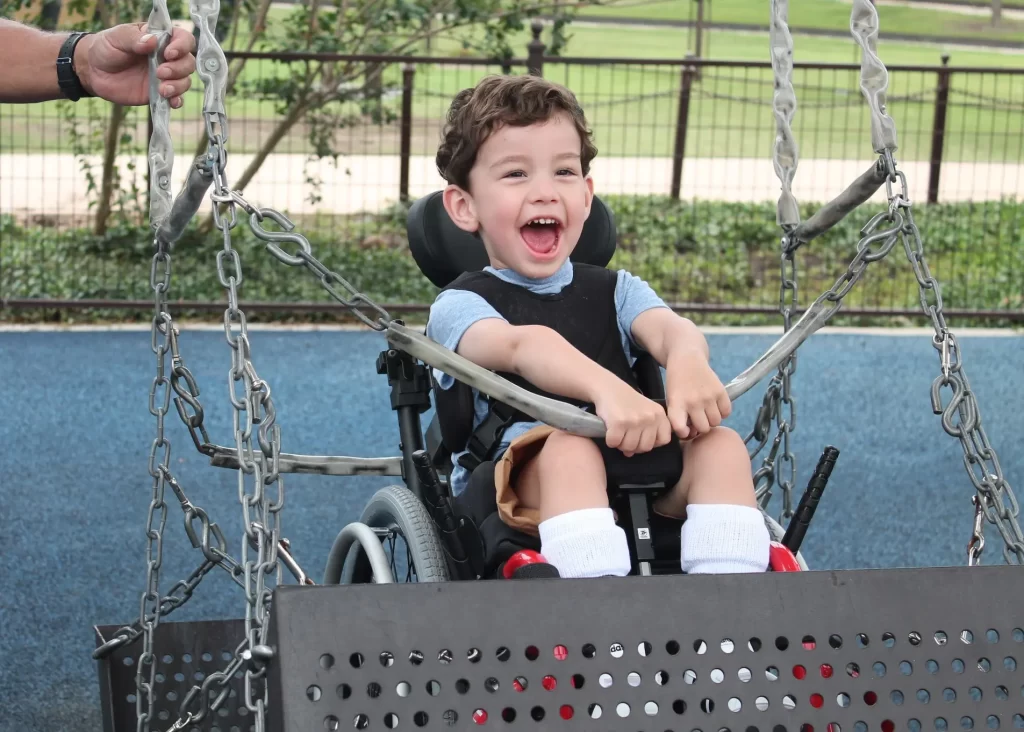 Picture of a little boy on a wheelchair swing