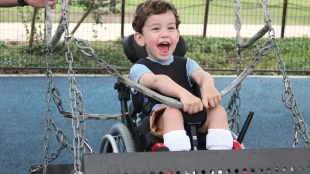 Picture of a little boy on a wheelchair swing