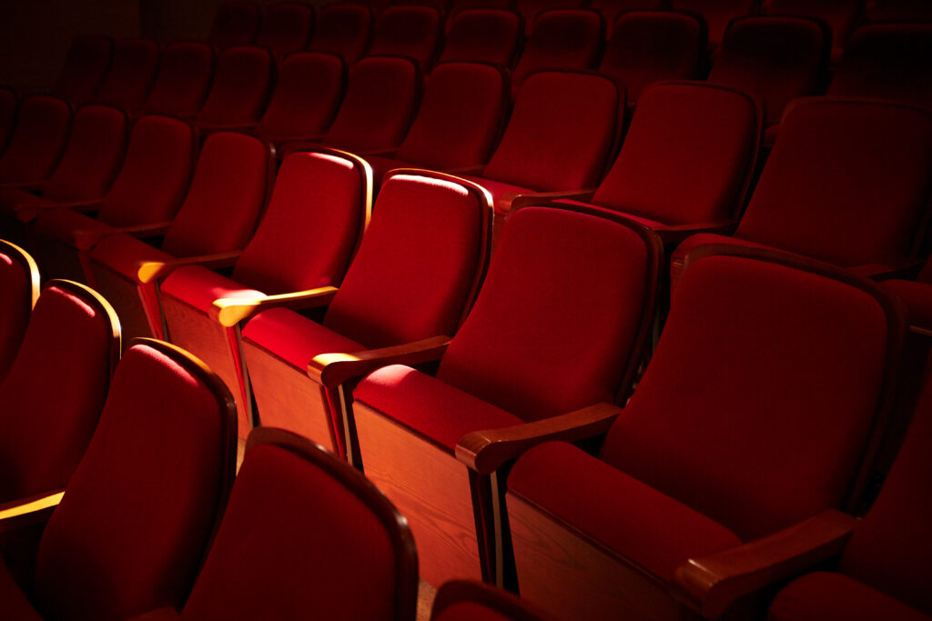 Rows of red seats at a theatre