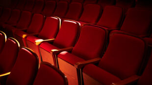 Rows of red seats at a theatre