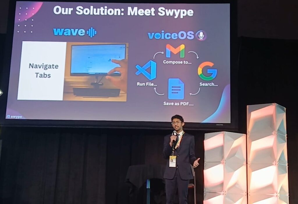 Young entrepreneur Dhanvin Ganeshkumar, dressed in a suit, presents on a stage at SXSW EDU. Behind him, a presentation slide for his solution, "Swype," shows its two components: "wave" for gesture control to navigate tabs and "voiceOS" for voice commands to perform tasks like searching Google or saving files.