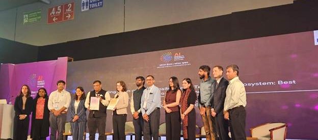 A diverse group of people on stage at the AI Summit held in New Delhi, India in February 2026.