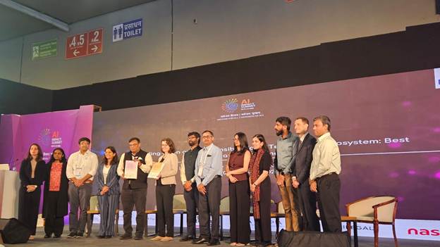 A diverse group of people on stage at the AI Summit held in New Delhi, India in February 2026.